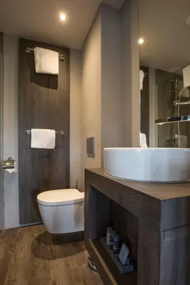a bathroom with a white sink and a toilet at Fletcher Boutique Hotel Duinoord in Wassenaar