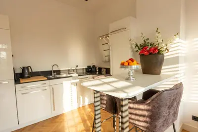 a kitchen with a table with a bowl of fruit on it at Spacious private apartement, 25min from Amsterdam in Hilversum
