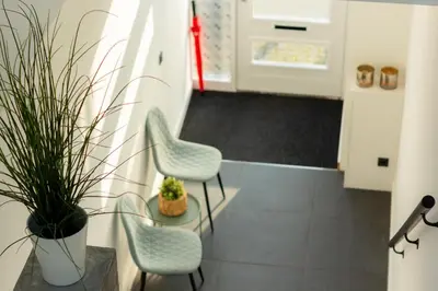 a kitchen with two chairs and a plant at Spacious private apartement, 25min from Amsterdam in Hilversum
