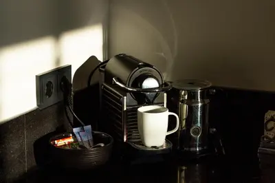 a kitchen counter with a coffee maker and a coffee cup at Spacious private apartement, 25min from Amsterdam in Hilversum