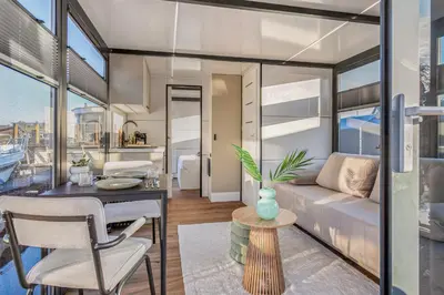 a living room and dining area of a apartment at Charming Tiny Houseboat Escape Near Amsterdam by Weltevreden Experience in Kortenhoef