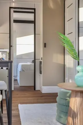 a room with a door leading to a bedroom at Charming Tiny Houseboat Escape Near Amsterdam by Weltevreden Experience in Kortenhoef
