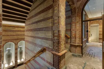 a brick wall with urinals on the side of a building at The College Hotel Amsterdam, Autograph Collection in Amsterdam