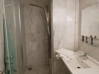 a bathroom with a shower and a sink and a shower at Huize de Duinen in Bergen aan Zee