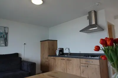 a kitchen with a sink and a counter top at Huize de Duinen in Bergen aan Zee