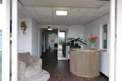 a living room with a couch and a table at Huize de Duinen in Bergen aan Zee