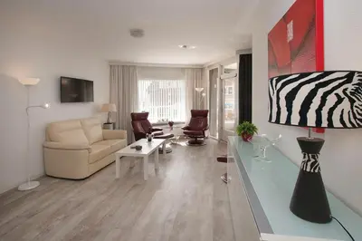 a living room with a couch and a table at Sterflat 61 in Egmond aan Zee