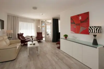 a living room with a couch and a table at Sterflat 61 in Egmond aan Zee