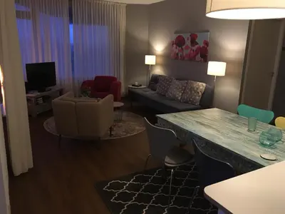 a living room with a couch and a table at Sterflat 65 in Egmond aan Zee