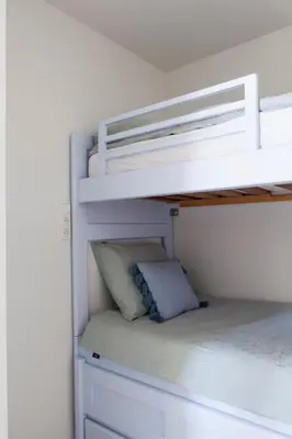 a white bunk bed with a pillow on the bottom bunk at Sterflat 63 in Egmond aan Zee