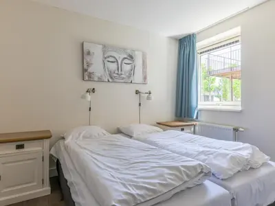 a bedroom with two beds and a window at Assum Great in Uitgeest