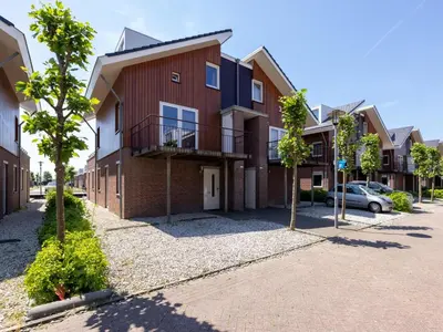 an apartment building with a car parked in the driveway at Assum Great in Uitgeest