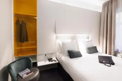 a hotel room with a bed and a chair at ibis Styles Amsterdam Central Station in Amsterdam