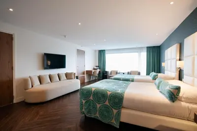 a hotel room with two beds and a couch at Van der Valk Hotel Akersloot / A9 ALKMAAR in Akersloot