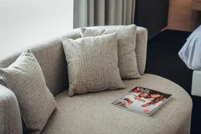 a book sitting on top of a couch with pillows at Van der Valk Hotel Akersloot / A9 ALKMAAR in Akersloot
