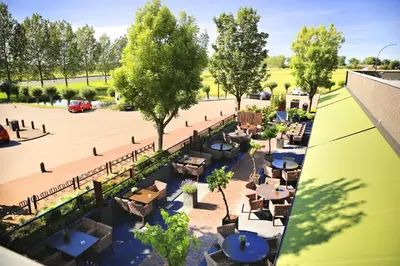 an overhead view of a patio with tables and trees at Van der Valk Hotel Akersloot / A9 ALKMAAR in Akersloot