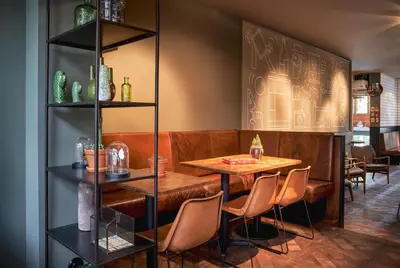 a dining room with a table and chairs at Max Brown Hotel Museum Square, part of Sircle Collection in Amsterdam