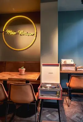 a dining room with a table and chairs and a cake at Max Brown Hotel Museum Square, part of Sircle Collection in Amsterdam