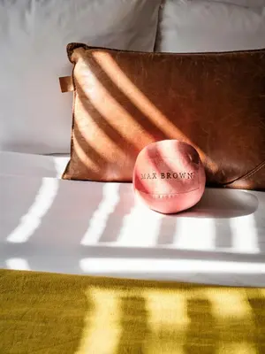 a pillow with the words waist brows on a bed at Max Brown Hotel Museum Square, part of Sircle Collection in Amsterdam