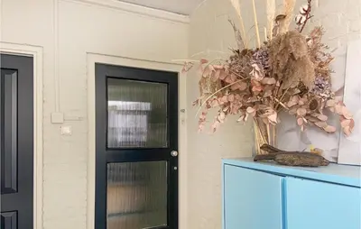 a room with a blue cabinet and a black door at Gorgeous Apartment In Katwijk Aan Zee in Katwijk aan Zee