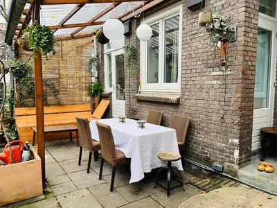 a table and chairs on the patio of a house at Appartement met 2 slaapkamers en tuin in Amsterdam in Amsterdam