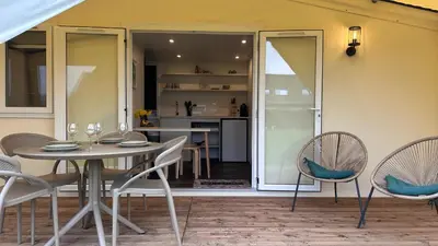 a dining room with a table and chairs and a kitchen at Glamping de Hof van Eeden in Warmond