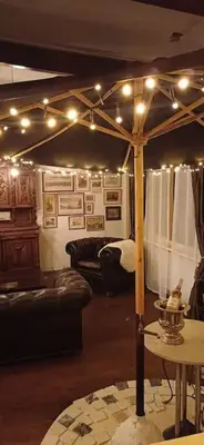 a living room with a canopy bed with lights at number 8 in Leiden