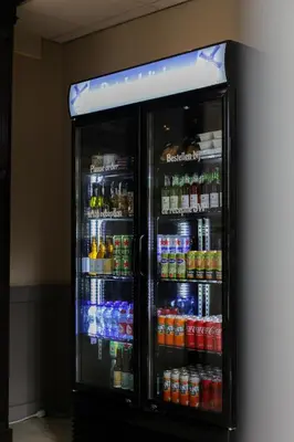 a refrigerator filled with lots of drinks and sodas at Hotel Heemskerk in Heemskerk