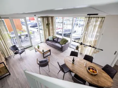 an overhead view of a living room with a table and chairs at Holiday Home De Meerparel by Interhome in Uitgeest