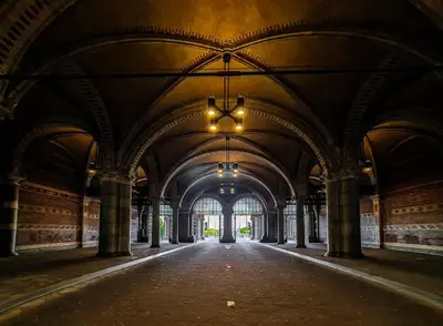 an empty arcade with a chandelier in a building at Hotel Alexander in Amsterdam