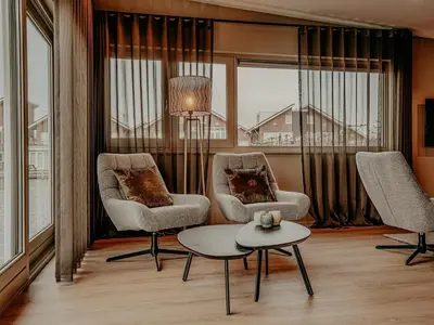 a living room with two chairs and a table at Houseboat in Netherlands with Private Dock in Uitgeest