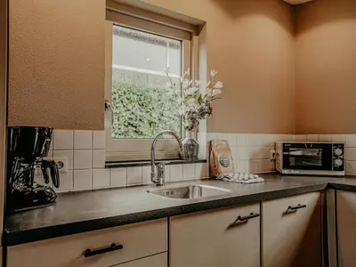 a kitchen with a sink and a window at Houseboat in Netherlands with Private Dock in Uitgeest