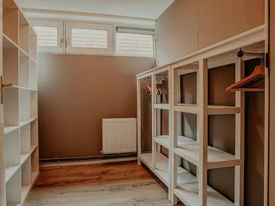 a walk in closet with white shelves at Houseboat in Netherlands with Private Dock in Uitgeest
