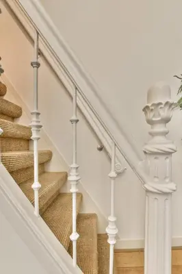 a staircase with white railings in a home at Amsterdam Alley Apartment in Amsterdam