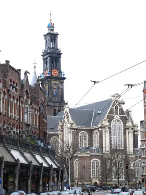 a large building with a clock tower in a city at Hotel Galerij in Amsterdam