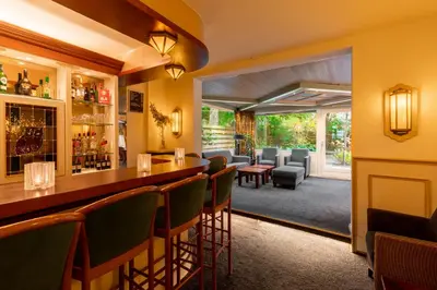 a bar in a restaurant with chairs and tables at Owl Hotel in Amsterdam