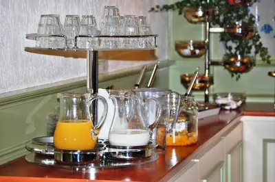 a kitchen counter with glasses of orange juice at Owl Hotel in Amsterdam