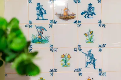 a tiled wall with blue and white tiles at Owl Hotel in Amsterdam