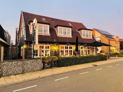 a building on the side of a street at Hotel Café Restaurant Heineke in Loosdrecht