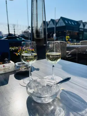 two glasses of white wine sitting on a table at Hotel Café Restaurant Heineke in Loosdrecht
