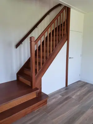 a wooden staircase in a house with wooden floors at Mathildahoeve in Warder