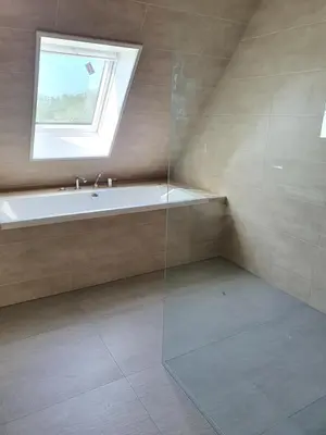 a bathroom with a bath tub and a window at Mathildahoeve in Warder