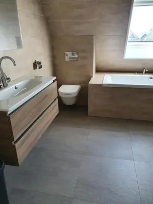 a bathroom with a tub and a toilet and a sink at Mathildahoeve in Warder