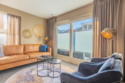 a living room with a couch and chairs and a table at Hotel De Koningshof in Noordwijk aan Zee