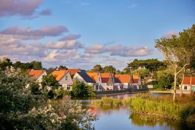 a row of houses next to a river at Beachhotel Zandvoort by Center Parcs in Zandvoort
