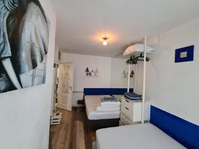 a small room with a bed and a bunk bed at Nice 2 double Bed in sunny House in Amsterdam west in Amsterdam