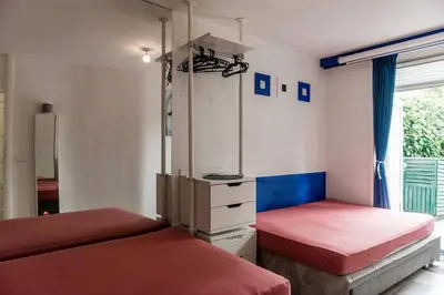 a bedroom with two beds and a mirror at Nice 2 double Bed in sunny House in Amsterdam west in Amsterdam