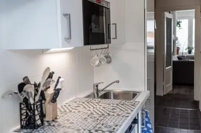 a kitchen with a sink and a counter top at Nice 2 double Bed in sunny House in Amsterdam west in Amsterdam