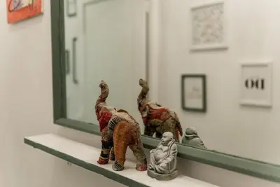 two figurines sitting on a shelf in front of a mirror at Nice 2 double Bed in sunny House in Amsterdam west in Amsterdam