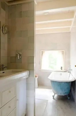 a bathroom with a tub and a sink and a window at Historical house on river Vecht in Maarssen